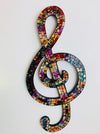 front view of mosaic treble clef on white background