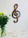 front view of mosaic treble clef hung on wall