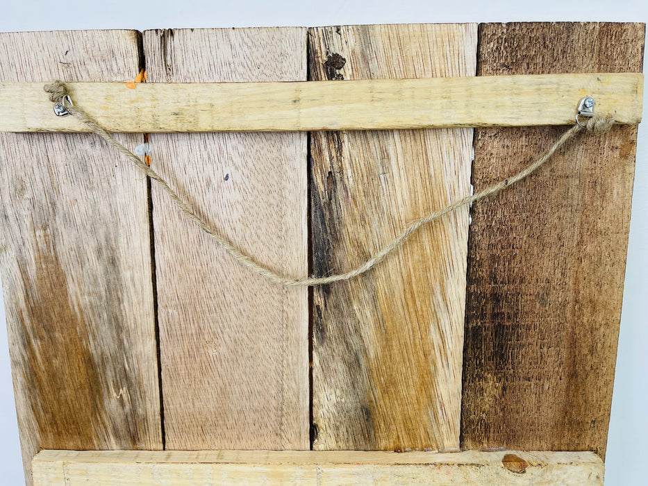 Back of Chat Noir wooden sign showing natural wood panels and hanging rope.