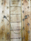 Back of In Our House wooden sign showing natural wood panels and hanging rope.